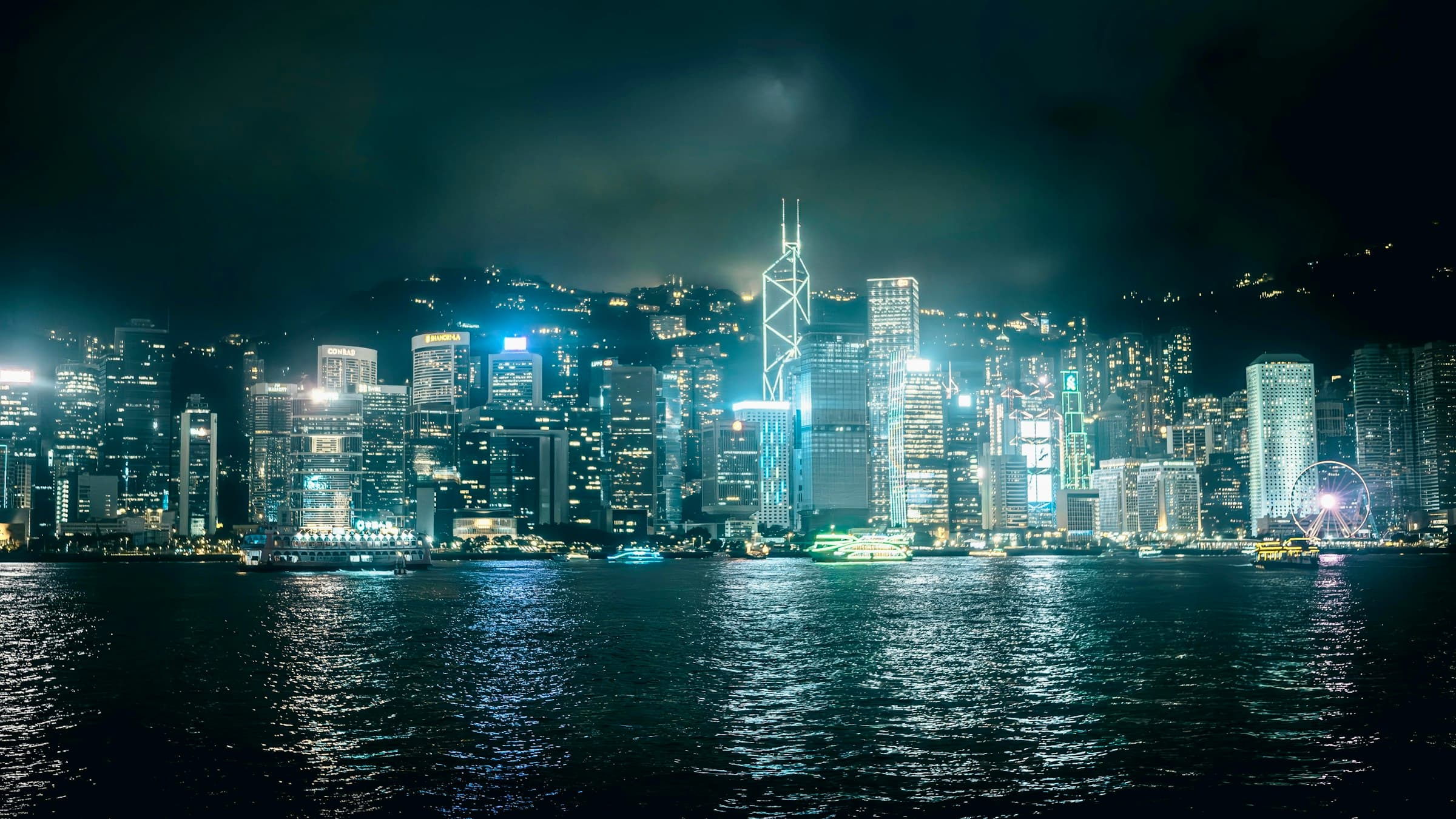 Victoria Harbour at night — city lights reflecting on the water, Hong Kong