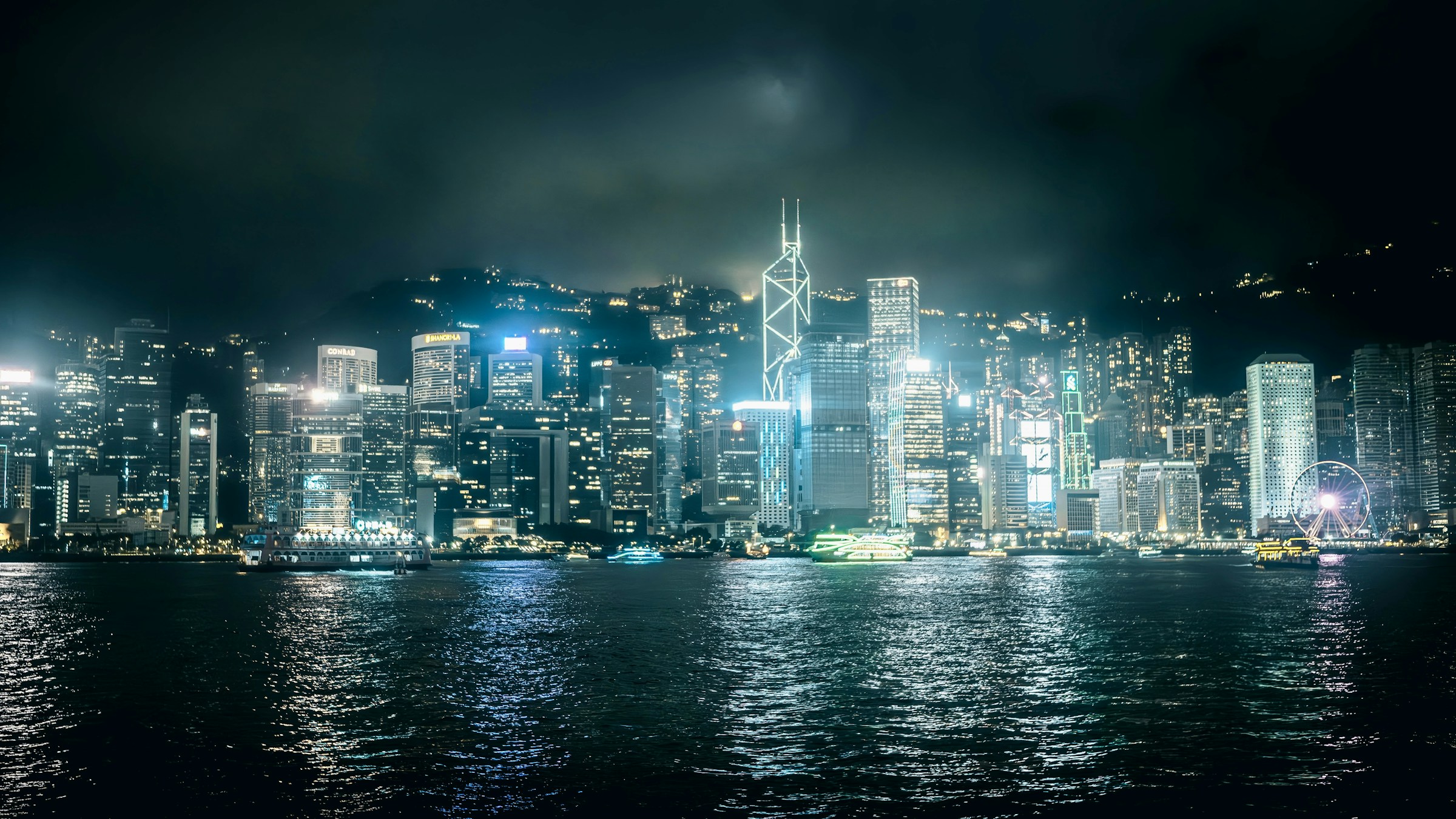 Victoria Harbour at night — city lights reflecting on the water, Hong Kong